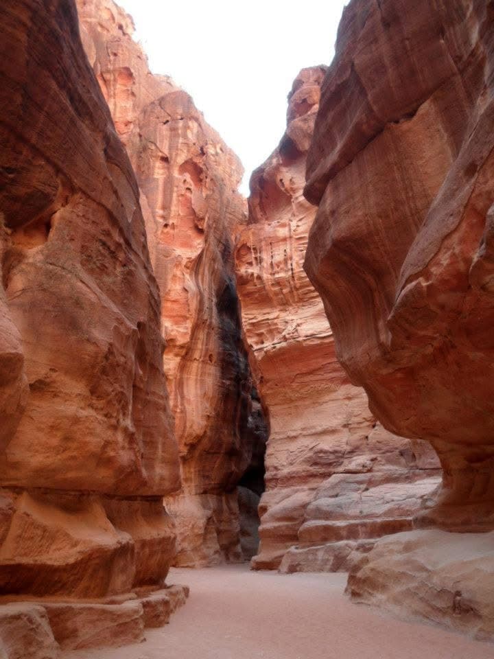 The Siq — the kilometre-long entrance canyon, sandstone walls narrowing to two metres before opening onto the Treasury
