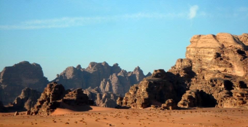 Wadi Rum at dusk — the jagged granite and sandstone skyline catching the last of the day's light