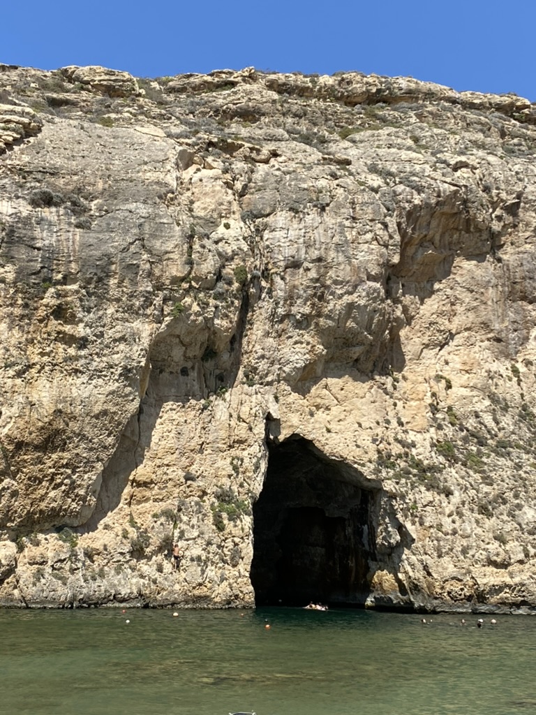 The Inland Sea tunnel entrance at Gozo — the opening in the cliff face leads through to a sheltered lagoon